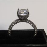 14ct white gold with large CZ solitaire stone with addional CZ stones addorning the upper part of