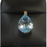 9ct yellow imported gold pendant set with a large pear cut blue topaz Approx 1.6 grams gross