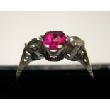 9ct yellow gold ring with a central ruby, flanked by 2 clear stones Approx 1.8 grams gross, size Q