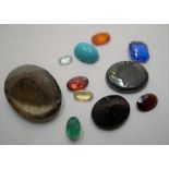 Various loose gemstones including 3 garnets, emerald, quartz, topaz etc
