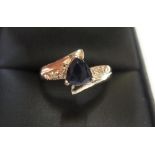 9ct yellow imported gold ring set with a trillion cut Iolite & small set diamonds to both