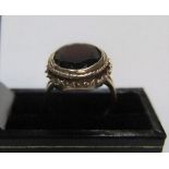 Large 9ct yellow gold ring set with a large oval cut garnet approx 5.8 grams gross, size L