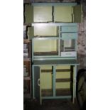 Large 1950s wooden kitchen storage unit with original paint. The unit is on casters and is in