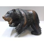 Large Black Forest bear in dark wood Approx 43 cm long by 25 cm high