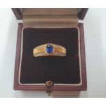 Asprey & Co 18ct yellow gold ring with central Sapphire with 6 diamonds in 2 lines to either side (