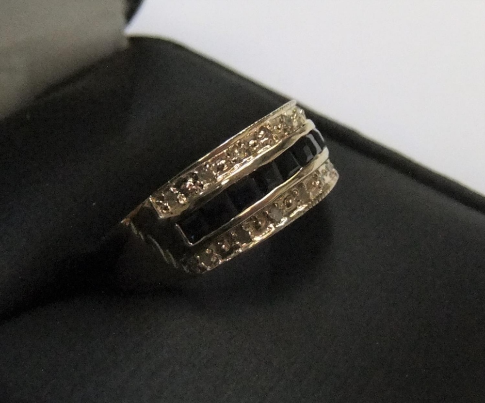 9ct yellow imported gold band ring with 9 square cut sapphires with a band of diamonds on either - Image 2 of 3