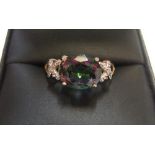 9ct yellow imported gold ring with a large oval cut mystic topaz with a small diamond to each
