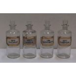 Set of 4 small antique clear glass, labelled chemists bottles, Each bottle is approx 18 cm high by 6