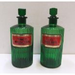 Pair of antique green glass, labelled, poison chemists bottles Each bottle measures approx 21 cm