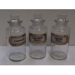 Set of 3 antique clear glass, labelled chemists bottles, Each bottle is approx 21 cm high by 8 cm in