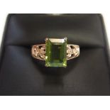 9ct yellow gold imported ring with a large Peridot stone with small diamonds to shoulders Approx 1.8