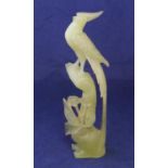 Finely carved jade statue of a bird amongst foliage 26cm high