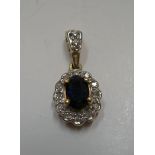 9ct yellow gold oval pendent set with a central oval cut sapphire surrounded with diamonds Approx