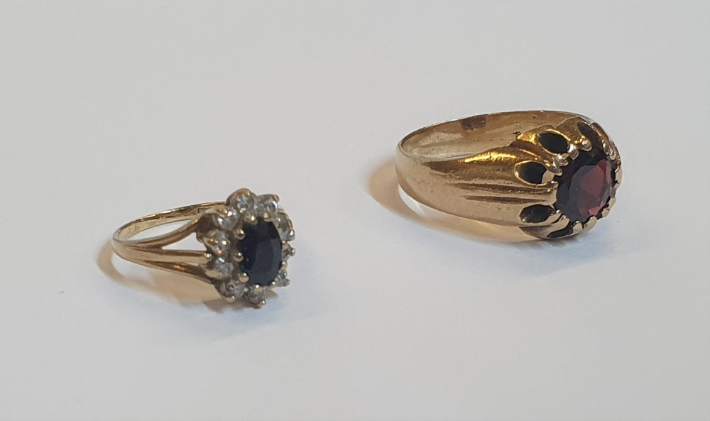2 yellow gold rings, 1 a heavy garnet solitaire, the other a Sapphire dress ring flanked by CZ ( - Image 2 of 3