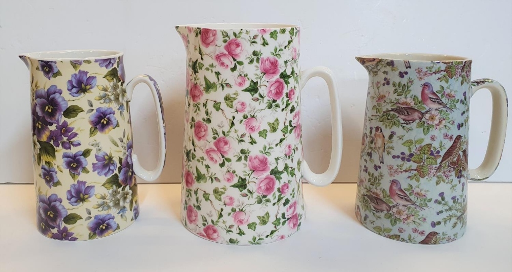 3 Staffordshire milk jugs with transfer printed patterns (2 Heron Cross Pottery, the other