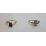 2 Sapphire 9ct yellow gold rings (2). The first a dark oval example the 2nd light blue Sapphire