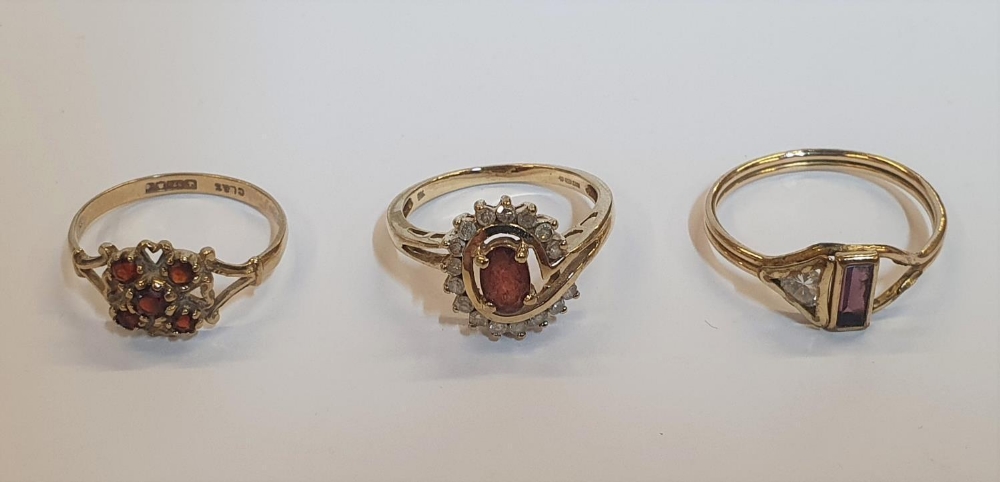 3 gold rings to include a 9ct yellow gold & oval cut Garnet surrounded by diamonds, another 9ct gold