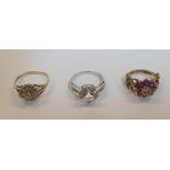 3 9ct gold rings (3) to include a large solitaire clear stone ring in white gold, a Ruby flower ring