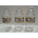 3 medium sized matching antique chemist bottles with complete labels, 17 cm high, excluding stopper