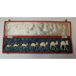 stunning boxed antique set of 7 graduating sized carved ivory camels in original red box, circa