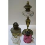 4 oil lamp items to include 2 hand-held oil lamps, an oil lamp with lighting fitment etc