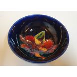 Moorcroft blue glazed floral bowl, 14 cm in diameter, Small chip under the glaze