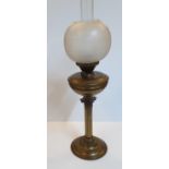 Victorian oil lamp with brass column and circular milk glass shade,