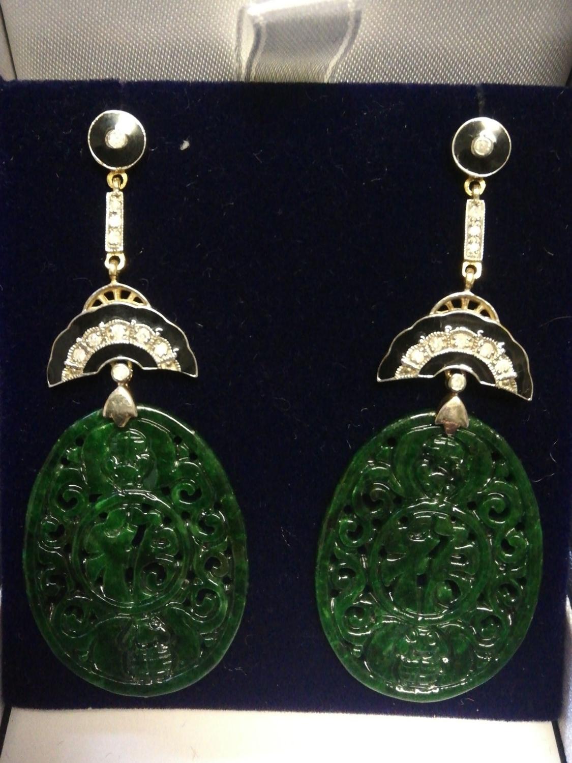 Pair of silver & gold drop earrings set with large oval patterned jade, diamonds & black enamel