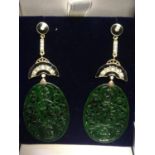 Pair of silver & gold drop earrings set with large oval patterned jade, diamonds & black enamel