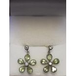 Pair of daisy style earrings set with peridot & diamonds