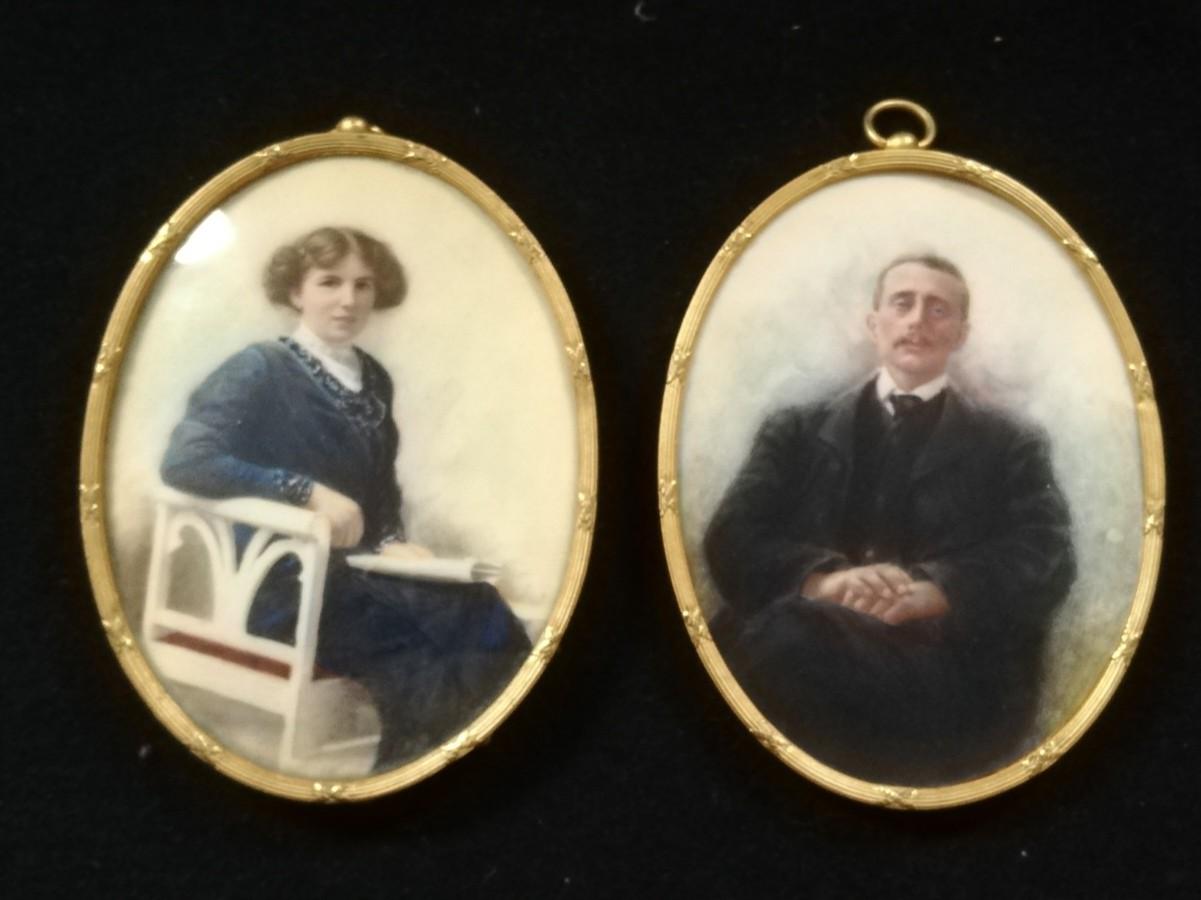 Pair of oval gilt metal framed portrait miniatures on ivory of Edwardian lady & gentleman