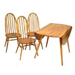 ERCOL; a light elm drop leaf dining table and three elm seated spindle back dining chairs (4).