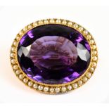 A 15ct yellow gold amethyst and seed pearl brooch, the modified brilliant cut amethyst weighing
