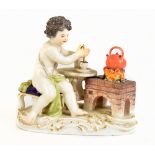 MEISSEN; a late 19th/early 20th century figure of a putto beside a kettle on a stove, blue crossed