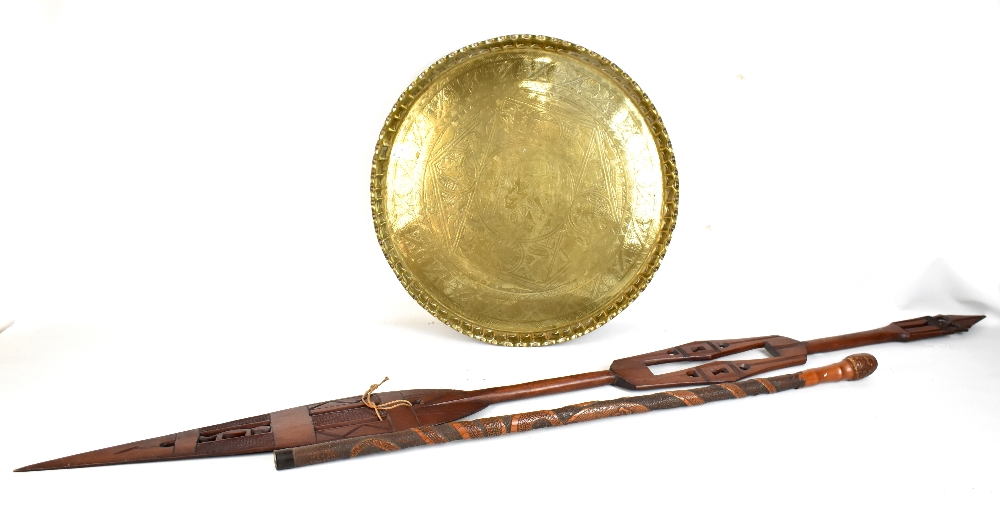 An African kaha paddle, length 160cm, a brass Benares table top and a bamboo walking cane (3).