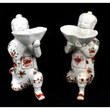 A pair of Chinese incense burners modelled as kneeling boys holding the bowl aloft, height 16.5cm.