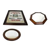 Two early 20th century oak framed wall mirrors and a reproduction Hunters Ale advertising wall