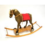 A plush model horse with tack on rocker base, approx 85 x 122cm (af).Additional InformationThe