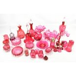A group of cranberry glass including decanter with clear stopper, bell, bowl, etcAdditional