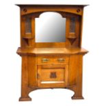 An Arts & Crafts oak mirror back sideboard, the central bevelled mirror flanked by copper panels