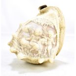 A carved conch shell depicting two cherubs beside a goat in landscape scene, height 16cm (af).