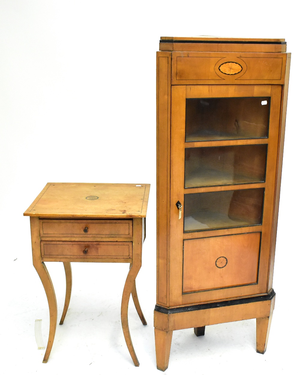 An early 20th century walnut and inlaid corner cabinet, the single glazed door enclosing three