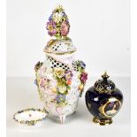 A large floral encrusted jar and cover, a Vienna transfer decorated gilt heightened jar and cover,