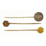 Three stick pins to include two 15ct gold examples with base metal pins, also an example mounted