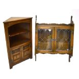 OLD CHARM; an oak wall cabinet with twin glazed doors above five hooks and a corner cupboard with