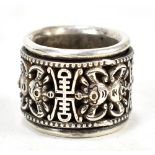 A Chinese silver archer's ring with rotating pierced band featuring stylised shou characters and