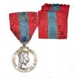 A Queen Elizabeth II Imperial Service medal, inscribed to rim 'Harry Burton'.