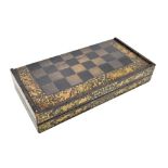 A 19th century Chinese lacquered and gilt games box with chess board to lid and backgammon board