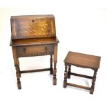 A 1920s/30s oak telephone stand with pull-down door enclosing fitted interior, with oak joint stool,