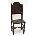 A 19th century oak Wainscot type single chair with carved decoration to back panel, raised on bun